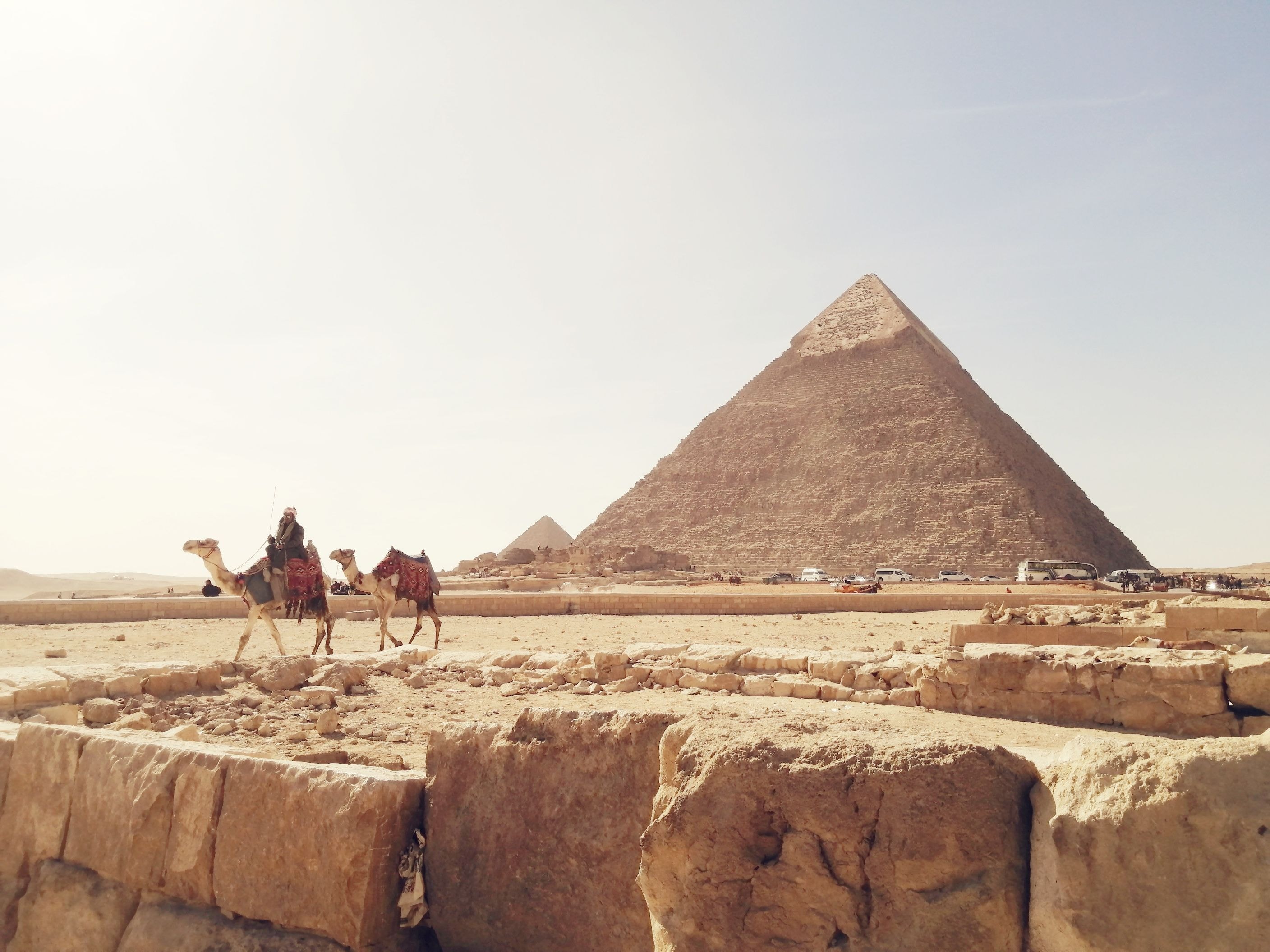 Traditional felucca sailing boat on the Nile with the Giza pyramids in the distance