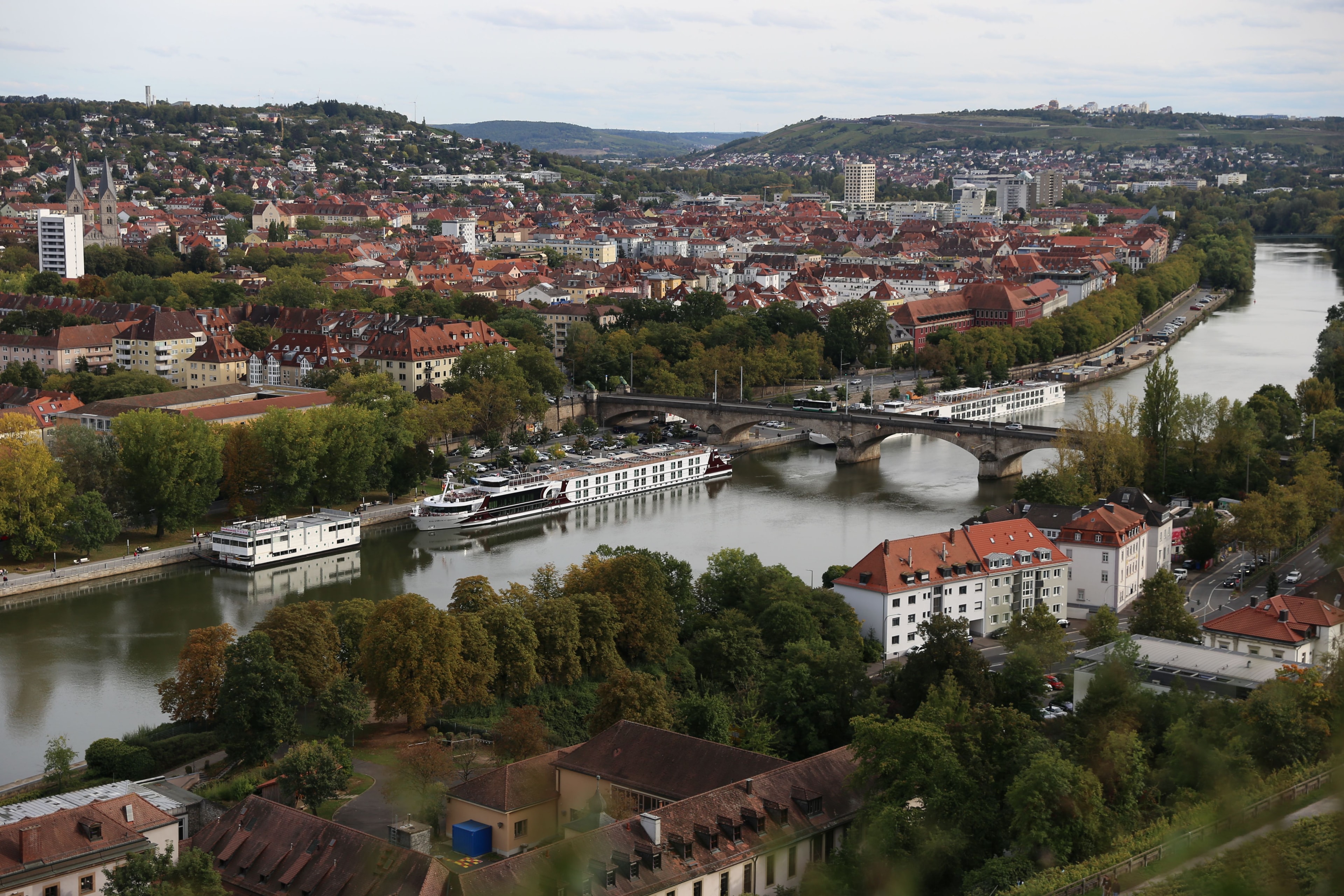 River cruise boat passing through a scenic European village